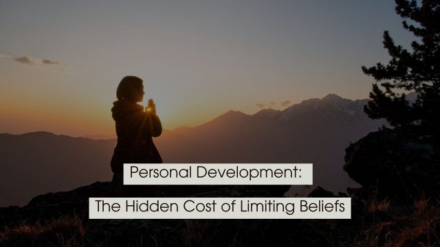 Silhouette of a person standing on a mountain at sunrise with hands clasped in reflection, with the text “Personal Development: The Hidden Cost of Limiting Beliefs” displayed across the image.