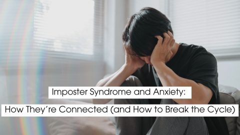 Person sitting on a couch holding their head in distress, illustrating imposter syndrome and anxiety, emotional overwhelm, self-doubt, and the mental health impact of chronic stress.