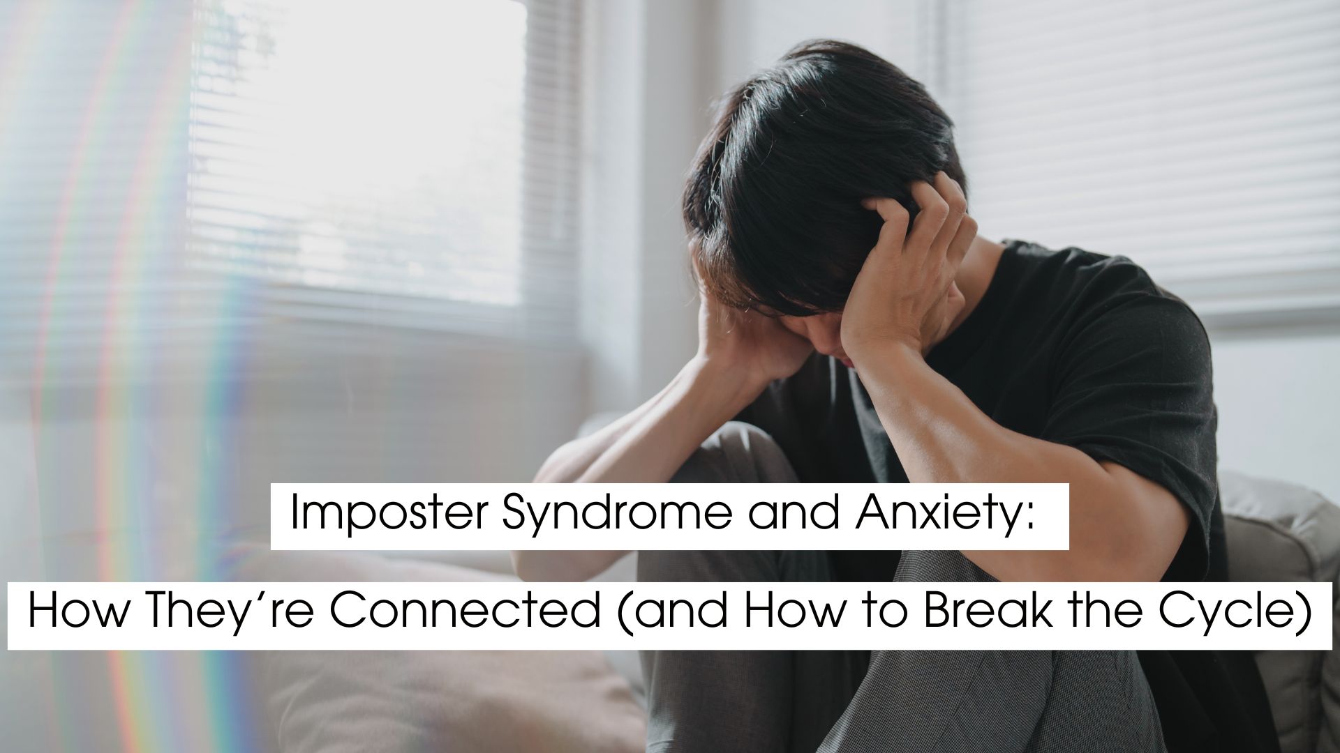 Person sitting on a couch holding their head in distress, illustrating imposter syndrome and anxiety, emotional overwhelm, self-doubt, and the mental health impact of chronic stress.