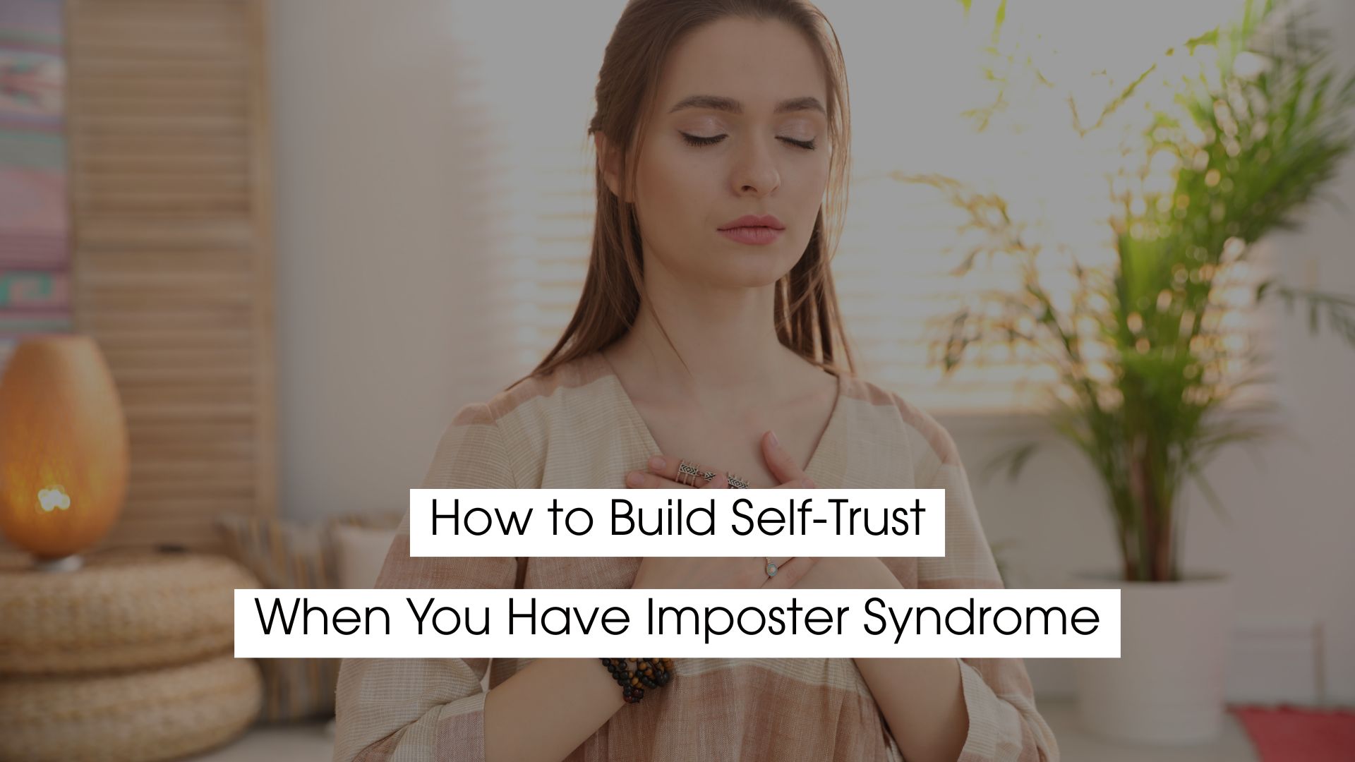 Woman with eyes closed and hands on her chest practicing calm breathing and self-reflection, symbolizing building self-trust, emotional grounding, and overcoming imposter syndrome.