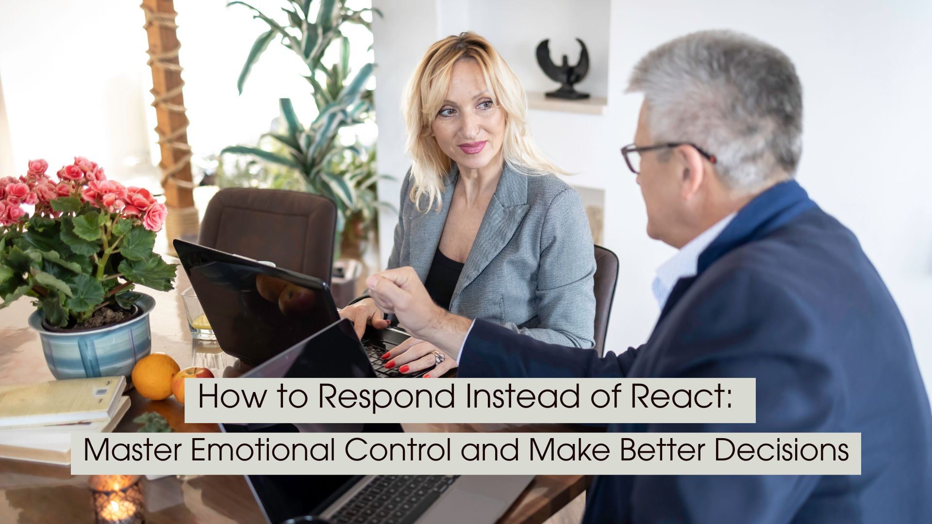 Two professionals sit across from each other at a table with laptops, engaged in a calm discussion, representing thoughtful communication, emotional control, and intentional decision-making, with the text “How to Respond Instead of React: Master Emotional Control and Make Better Decisions” displayed across the image.