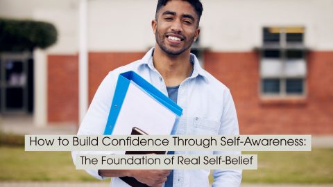 A smiling young man stands outdoors holding folders and a notebook, representing self-confidence, personal growth, and self-awareness, with the text “How to Build Confidence Through Self-Awareness: The Foundation of Real Self-Belief” displayed across the image.