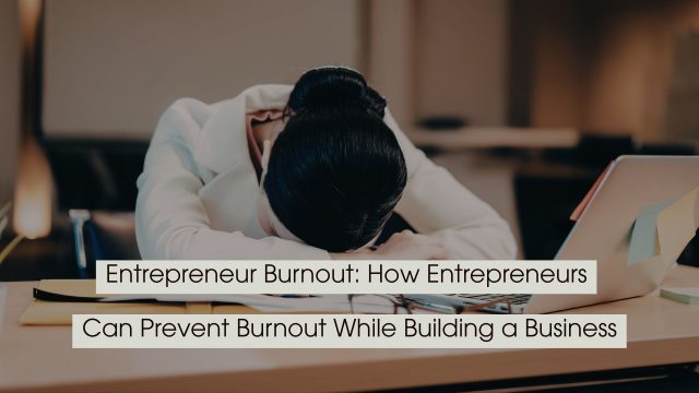 Exhausted entrepreneur resting their head on a desk beside a laptop and paperwork, with the text “Entrepreneur Burnout: How Entrepreneurs Can Prevent Burnout While Building a Business” displayed across the image.