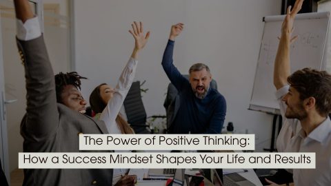 Team of colleagues raising their hands enthusiastically in a meeting, representing positivity and success mindset, with the text “The Power of Positive Thinking: How a Success Mindset Shapes Your Life and Results” displayed across the image.