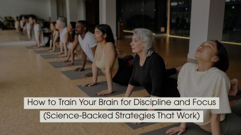 Group of people practicing yoga in a studio, focusing on breathing and posture, symbolizing mental discipline and focus, with the text “How to Train Your Brain for Discipline and Focus (Science-Backed Strategies That Work)” displayed across the image.