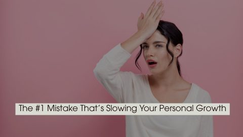 Woman with a surprised expression touching her forehead against a pink background, symbolizing realization of a mistake, with the text “The #1 Mistake That’s Slowing Your Personal Growth” displayed across the image.