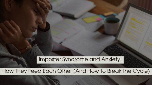 Stressed person sitting at a desk with head in hand beside an open laptop and scattered papers, representing imposter syndrome and anxiety.