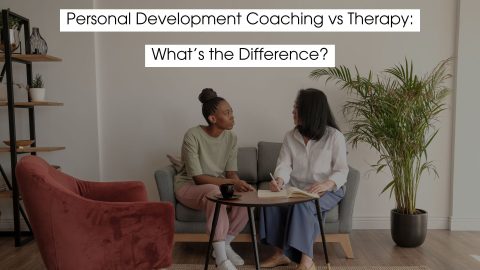 Two women sitting in a calm coaching or therapy setting, having a focused conversation, with text overlay reading “Personal Development Coaching vs Therapy: What’s the Difference?”