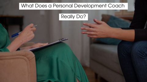 Personal development coach listening to a client during a one-on-one coaching session, with text overlay reading “What Does a Personal Development Coach Really Do?”