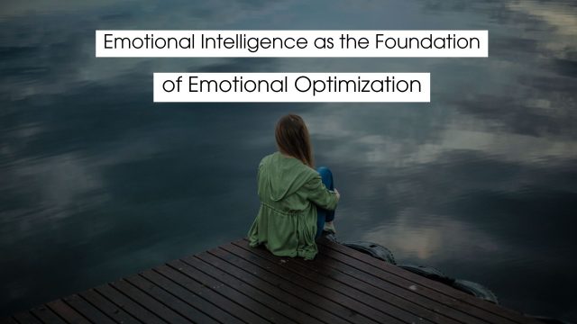 Person sitting quietly on a wooden dock overlooking calm water, reflecting on emotions and mindfulness, representing emotional intelligence as the foundation of emotional optimization.