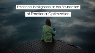 Person sitting quietly on a wooden dock overlooking calm water, reflecting on emotions and mindfulness, representing emotional intelligence as the foundation of emotional optimization.