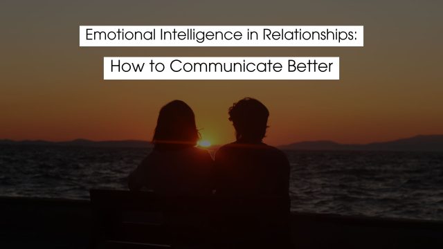 Silhouetted couple sitting together by the ocean at sunset, symbolizing emotional intelligence in relationships, connection, empathy, and better communication.