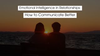 Silhouetted couple sitting together by the ocean at sunset, symbolizing emotional intelligence in relationships, connection, empathy, and better communication.