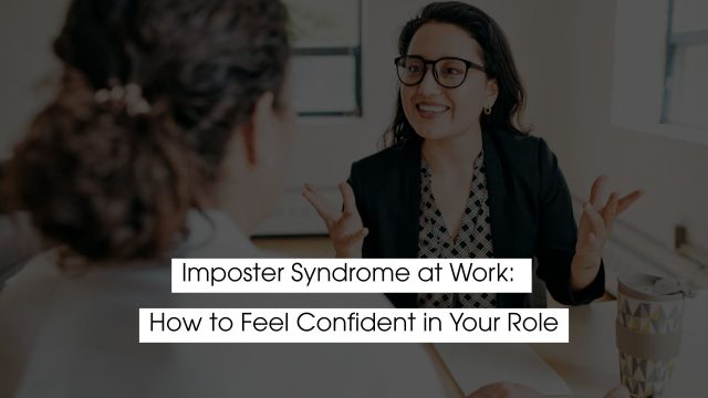 Professional woman confidently speaking during a workplace conversation, representing imposter syndrome at work and learning how to feel confident in your role.