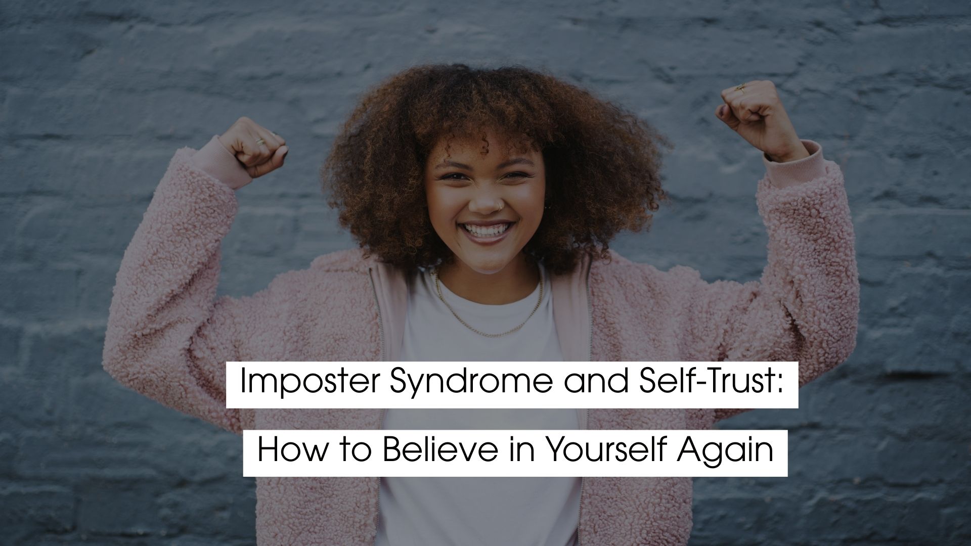 Smiling woman with curly hair raises her fists in a confident pose against a blue wall, with the text “Imposter Syndrome and Self-Trust: How to Believe in Yourself Again.”