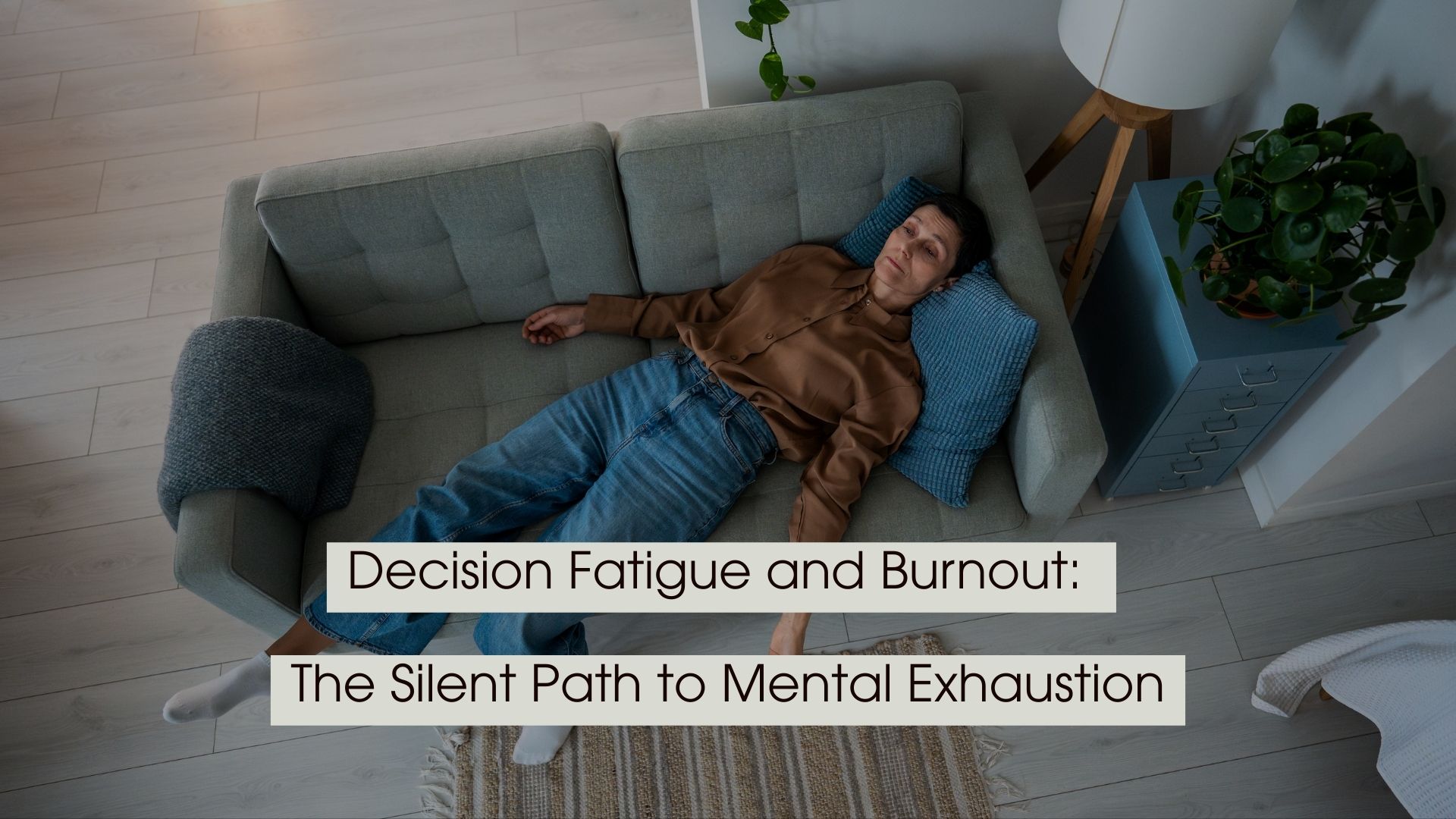 Person lying on a couch looking mentally drained in a quiet living room, with the text “Decision Fatigue and Burnout: The Silent Path to Mental Exhaustion” displayed across the image.
